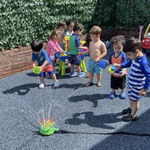 Children playing with a water sprinkler